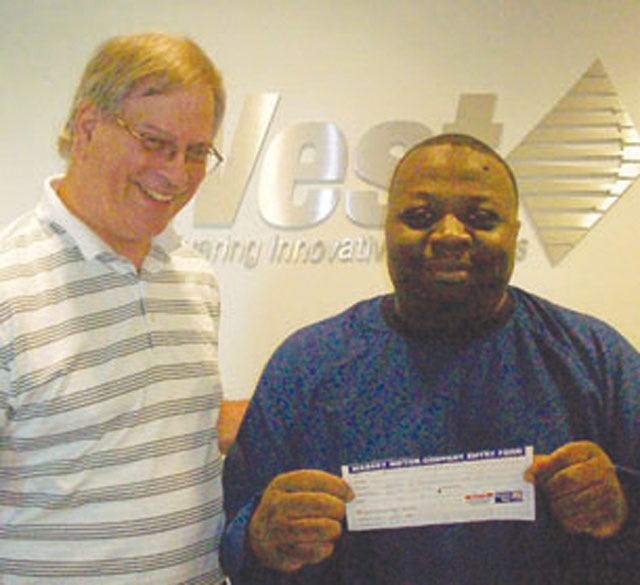 Out of more than 525 entries, Kevin Morgan, right, with West Pharmaceutical Services Inc., was the third entry selected. With his donation to Lenoir/Greene United Way, he is one of 10 who will try to win the 2011 Toyota Corolla from Massey Motor Company. Keith Montgomery, a West Pharmaceutical Services colleague, celebrates with Morgan.