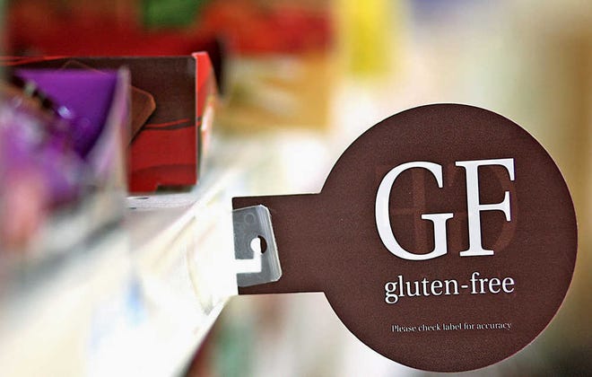 In this Sept. 20, 2012 photo, one of several shelf tags noting gluten free products is seen in the health market section of a grocery store in Sycamore, Ill. "Gluten free" has become something of a buzzword as more people are diagnosed with gluten sensitivities or celiac disease. (AP Photo/DeKalb Daily Chronicle, Kyle Bursaw)  MANDATORY CREDIT, CHICAGO LOCALS OUT, ROCKFORD REGISTER STAR OUT