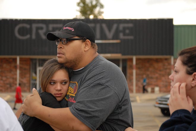 Lorenzo Cook hugs Silvia Cook at Cimarron Plaza in Stillwater. Students were taken there to meet their parents following a suicide at Stillwater Junior High School. PHOTO BY JONATHAN SUTTON, FOR THE OKLAHOMAN