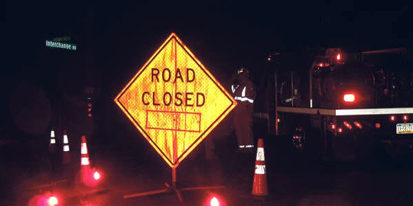 A road closed sign blocks Route 209 in Kresgeville after a single-vehicle crash knocked down power lines Tuesday evening. Two occupants of the vehicle were flown from the scene by medical helicopter.