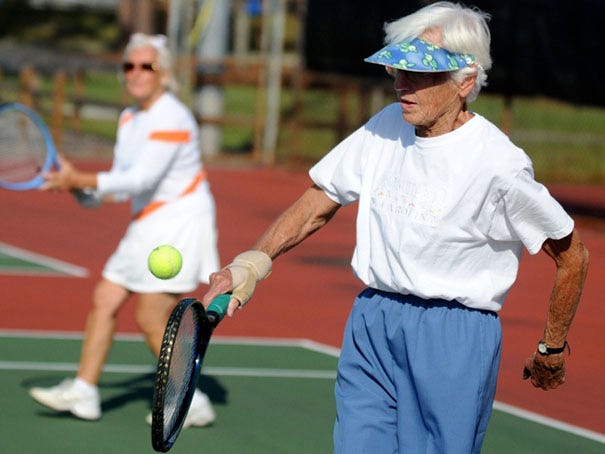 Mariette Lisnet, 75, returns a shot while doubles partner Wendy Kider watches during a tennis match at the Althea Gibson Tennis Complex on September 21, 2012.