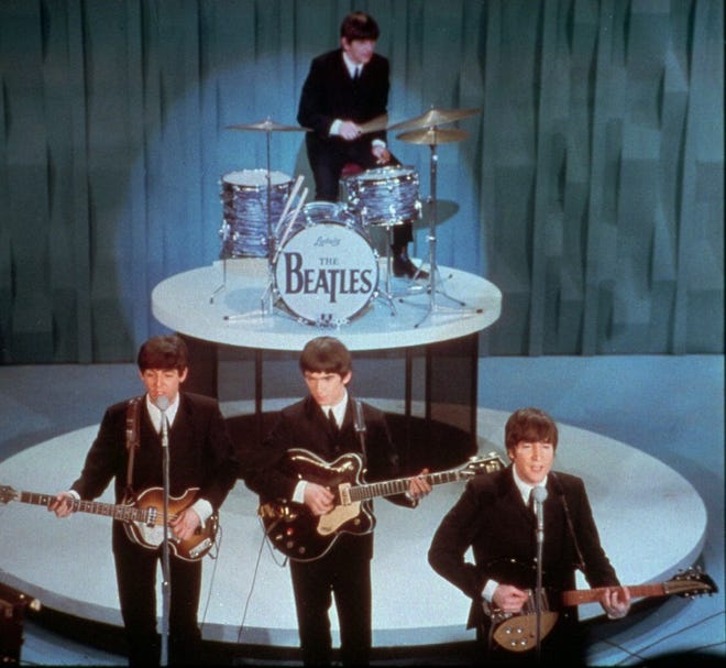 FILE - The Beatles perform at the "Ed Sullivan Show," in New York in this Feb. 9, 1964 file photo. Universal Music Group can buy the famed British music company EMI, including the hugely lucrative Beatles catalogue, the European Union's competition regulator said Friday Sept 21 2012, but must jettison some of the famed label’s other big acts, including Coldplay and Pink Floyd. (AP Photo)