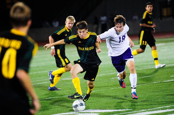 Rock Bridge’s Patrick Bromstedt battles Hickman’s Peter Plakorus (19) for the ball during the second half of the Bruins’ 3-1 win.