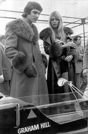 French film actress Bridget Bardot talks with French racing driver Francois Cevert, at the Racing Car Show, in Paris, France, Feb. 12, 1971, as they admire the racing car of Britain's Graham Hill.. (AP Photo/Marqueton)