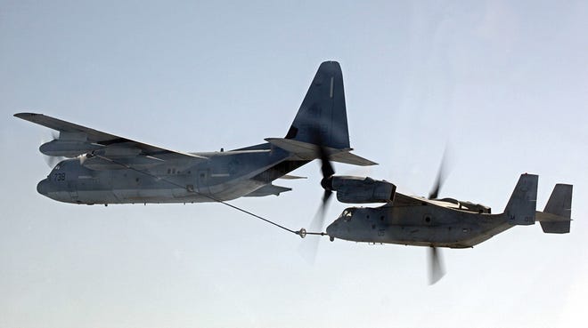 A MV-22B Osprey, right, and a KC-130J Hercules, both with Marine Medium Tiltrotator Squadrom 261, conduct aerial refueling training operations Sunday.