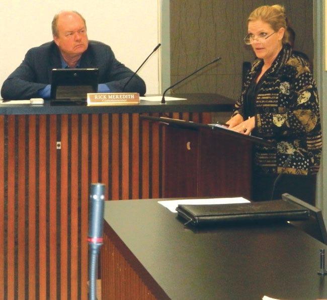 Anderson County Mayor Terry Frank, right, asks for written clarification on how the Briceville library construction is to be paid for. At left is Commissioner Rick Meredith.