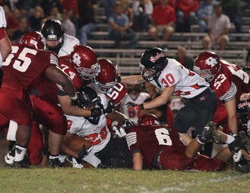Coady Perez, 74, Tre Spratling, 50, and Elliott Normand, 6, combine to tackle Maryville running back Shawn Prevo last week. Darius Patterson, 65, and Tim Grabenstein, 53, are also nearby. The Oak Ridge front seven will have to play the run and pass well this week against Anderson County.