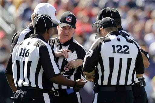 Replacement officials huddle in the second quarter of an NFL football game between the New England Patriots and the Arizona Cardinals, Sunday, Sept. 16, 2012, in Foxborough, Mass. (AP Photo/Elise Amendola)