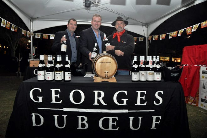 The George Duboeuf team stands ready to pour at last year's Beaujolais Nouveau celebration in Grand Boulevard at Sandestin.