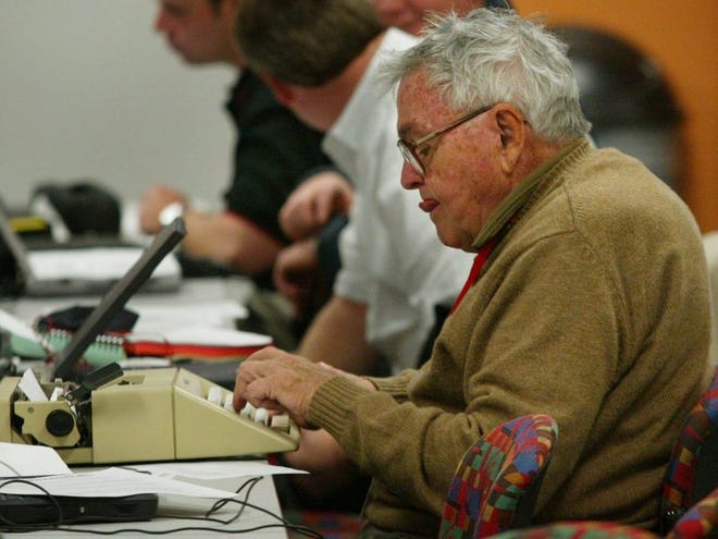 Chris Economaki works on his trusty typewriter in the infield media center at Daytona International Speedway on Feb. 14, 2003.