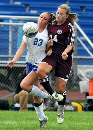 Ellwood City's Ashley Lytle (23) and Beaver's Alexis Stahl battle for a loose ball during a match in September 2011.