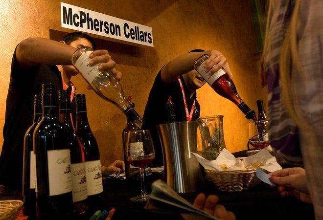 Vendors pour wine during the 2012 Lubbock Wines and Vines Festival at McPherson Cellars on Friday.