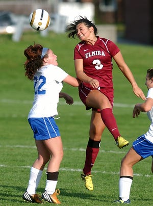 Elmira's Bee Bulkley heads the ball over Horseheads' Crystal Powers. Eric Wensel/The Leader