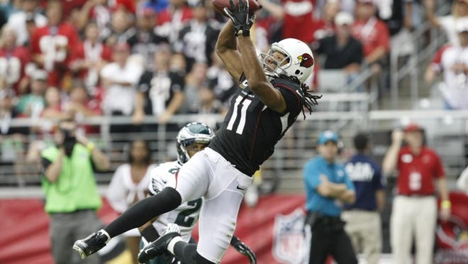 ** RAW FILE** Arizona Cardinals' Larry Fitzgerald (11) makes a jumping touchdown catch in front of Philadelphia Eagles' Nnamdi Asomugha in the first half of an NFL football game on Sunday, Sept. 23, 2012, in Glendale, Ariz. (AP Photo/Rick Scuteri)