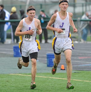 Jackson junior Ben Hyde (left) and senior Alex Mallue compete during the 2011 Stark County Cross Country Championships at GlenOak. Both will compete Saturday as the Polar Bears seek to defend their team title.