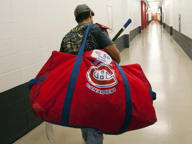 Montreal Canadiens' Francis Bouillon arrives for an informal training session, Monday, Sept. 17, 2012, at the team's training facility in Brossard, Quebec.