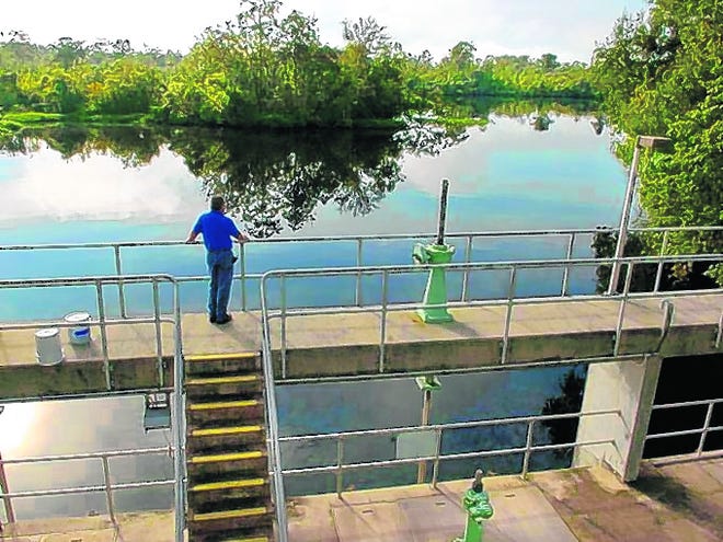 An employee of the Peace River-Manasota Regional Water Supply Authority stands on an intake structure in DeSoto County by which water is diverted from the river to a reservoir. The facility was funded in part by the 
Southwest Florida Water Management District.