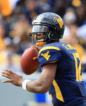 West Virginia quarterback Geno Smith (12) looks for a receiver during their NCAA college football game against Baylor in Morgantown, W.Va., Saturday, Sept. 29, 2012. (AP Photo/Christopher Jackson)