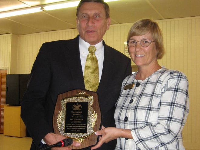 U.S. Rep. John Mica, left, receives a plaque for his service to the city of Bunnell from Mayor Catherine Robinson.
