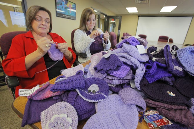 Penny Hill-Malone and Aimee Merick crochet purple caps for the "Click for Babies" program to raise awareness about normal infant crying and the dangers of shaking a baby. Photo by David McDaniel, The Oklahoman