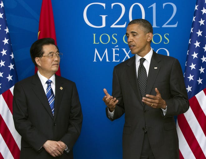FILE - In this June 19, 2012 file photo, President Barack Obama speaks as he attends a bilateral meeting with Chinas President Hu Jintao during the G20 Summit, in Los Cabos, Mexico. Citing national security risks, Obama on Friday, Sept. 28, 2012, blocked a Chinese company from owning four wind farm projects near a Navy base where the U.S. military flies unmanned drones and electronic-warfare planes on training missions. It was the first time in 22 years that a U.S. president has blocked such a foreign business deal. (AP Photo/Carolyn Kaster, File) ORG XMIT: NY128