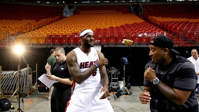 092812 (Gary Coronado/The Palm Beach Post) -- Miami -- LeBron James fools around with friend Randy Mims before a television interview at the Miami Heat media day at the AmericanAirlines Arena in Miami on Friday. (Gary Coronado/The Palm Beach Post)