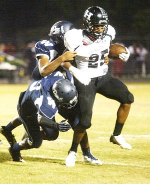 Havelock running bacl Tayllor Woods fights for yardage during the Rams' 34-7 win over Washington on Friday.