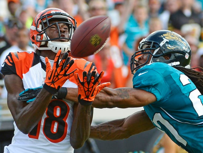 Cincinnati Bengals wide receiver A.J. Green (left) catches a pass for a 42-yard gain in front of Jaguars cornerback Rashean Mathis during the first half on Sunday at EverBank Field.