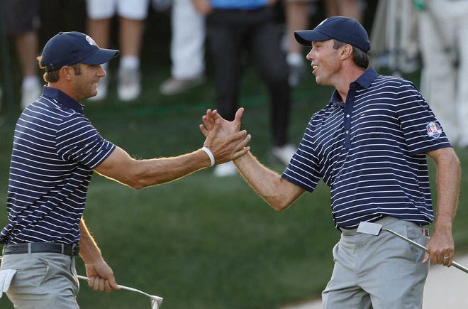 USA's Matt Kuchar, right, and Dustin Johnson celebrate after winning the 17th hole during a four-ball match at the Ryder Cup tournament Saturday at the Medinah Country Club in Medinah, Ill.