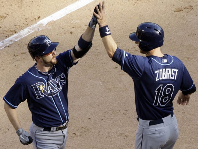 Tampa Bay Rays' Jeff Keppinger, left, celebrates with Ben Zobrist after hitting a two-run home run during the third inning of a baseball game against the Chicago White Sox in Chicago, Saturday, Sept. 29, 2012.