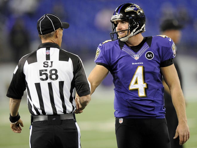 Side judge Jimmy DeBell greets punter Sam Koch before the Ravens game Thursday, Sept. 27, 2012, against the Cleveland Browns in Baltimore.