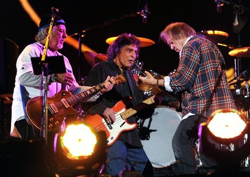 Musician Neil Young, right, performs with his band Crazy Horse including Frank Sampedro, left, and Ralph Molina, at the Global Citizen Festival in Central Park on Saturday.