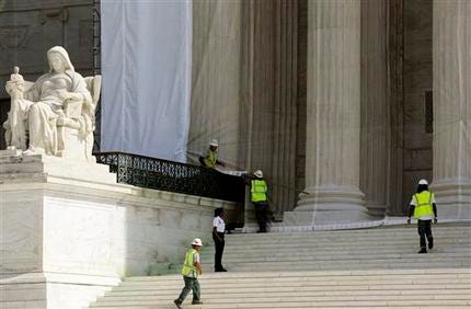 Workers cover the U.S. Supreme Court building in Washington Thursday, Sept. 27, 2012, with a protective scrim, as work continues on the facade. The Supreme Court is embarking on a new term beginning Monday that could be as consequential as the last one with the prospect for major rulings about affirmative action, gay marriage and voting rights.