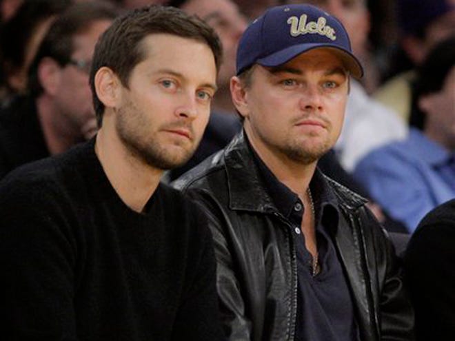 FILE - In this Dec. 22, 2009, file photo, actors Tobey Maguire, left, and Leonardo DiCaprio watch an NBA basketball game between Los Angeles Lakers and the Oklahoma City Thunder in Los Angeles. DiCaprio and Maguire lead a cast of stars in a new public service announcement urging young voters to use social media to express the issues most important to them in the upcoming election.(AP Photo/Jae C. Hong, File)