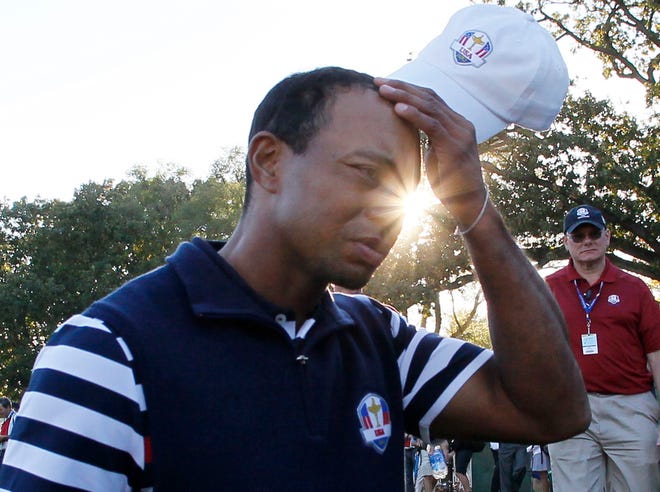 USA’s Tiger Woods scratches his head as he walks off the course after the Ryder Cup PGA tournament Sunday at the Medinah Country Club in Medinah, Ill.