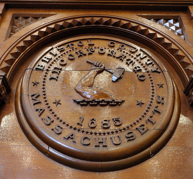 A carved wood county seal graces one of the mantels of the main courtroom on the econd floor.