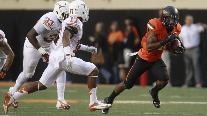 Oklahoma State running back Joseph Randle eludes Texas' Steve Edmond and Adrian Phillips and takes off on a 69-yard touchdown run in the first quarter in Stillwater, Okla., Saturday, Sept. 29, 2012.