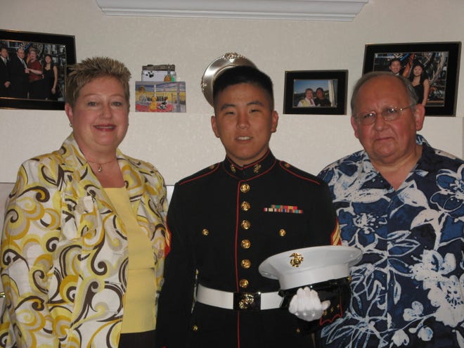 Sgt. Carl Robert Gunnerson, with the U.S. Marine Corps takes a photo with his parents – Mary Beth and Rob Gunnerson – on Mother’s Day, 2008 after his return from Iraq.