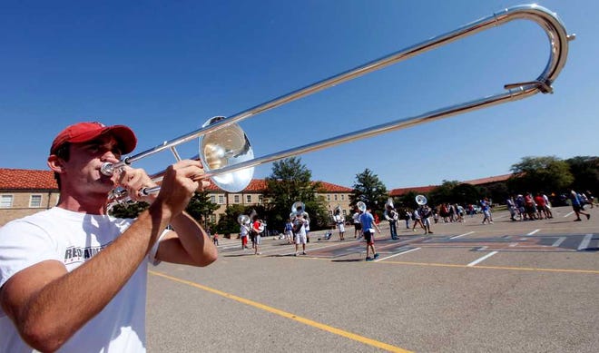 Joseph McPherson plays one of the newly purchased trombones before the Goin' Band from Raiderland rehearsal at Texas Tech on Tuesday.