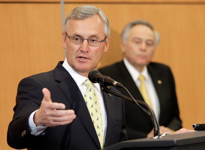 Former Ohio State football coach Jim Tressel speaks after being introduced as the new vice president for strategic engagement at the University of Akron Thursday, Feb. 2, 2012, in Akron, Oho. University president Luis M. Proenza listens, right.