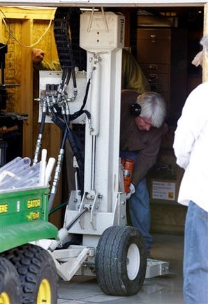 In a Sept. 28, 2012 file photo authorities drill for soil samples in the floor of a shed at a Roseville, Mich., home Friday, Sept. 28, 2012. Police have been told by a source that former Teamsters boss Jimmy Hoffa may be buried beneath a driveway. Like many others that came before it, the latest search for Hoffa has come up empty. Tests on soil samples gathered last week from a backyard in suburban Detroit showed no traces that Hoffa — or anyone else — was buried there, Roseville police announced Tuesday, Oct. 2.