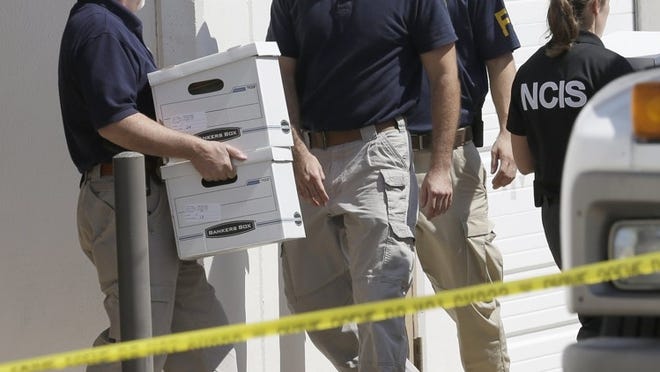 Federal agents carry boxes out of Arc Electronics Inc. Wednesday in Houston. A Kazakhstan-born businessman was charged in the U.S. on Wednesday with being a secret Russian agent involved in a scheme to illegally export microelectronics from the United States to Russian military and intelligence agencies.