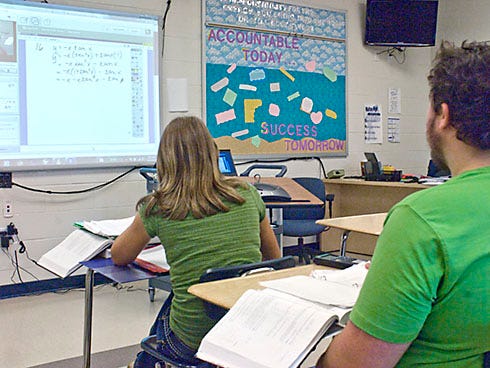 Students in a Walton High School classroom monitor a calculus class being held in a South Walton High School classroom on Wednesday morning.