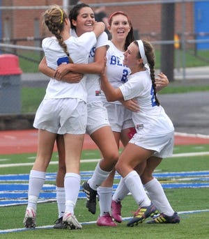Pleasant Valley's Kaitlyn Smith, left, hugs Keri Dekmar, who scored the games wining goal, as teammates Emily Schlogl and Gabby Lucchese also celebrate, on Wednesday, October 3, 2012. Pleasant Valley won the game against Pocono Mountain West 1-0.