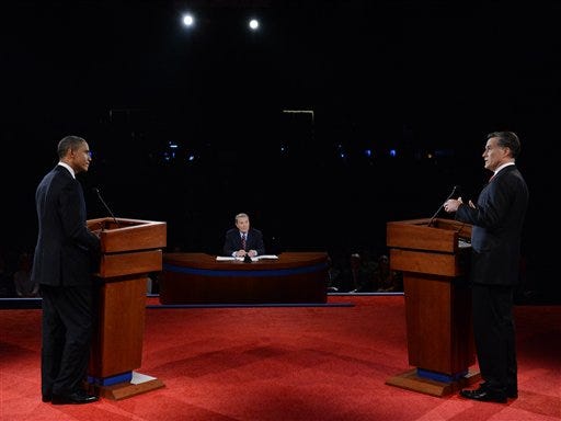 President Barack Obama watches as Republican presidential nominee Mitt Romney answers a question during the first presidential debate at the University of Denver, Wednesday, Oct. 3, 2012, in Denver.