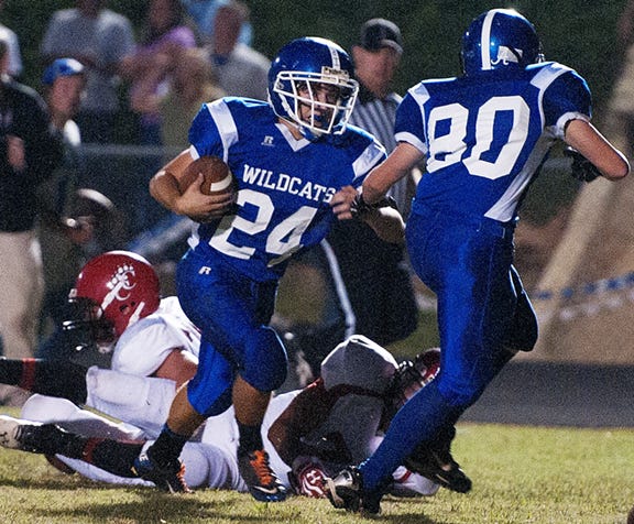 South Davidson's Preston Owens follows teammate Cord McDowell (right) as Owens breaks a tackle on a long run that set up a touchdown on the next play against Chatham Central on Friday night.