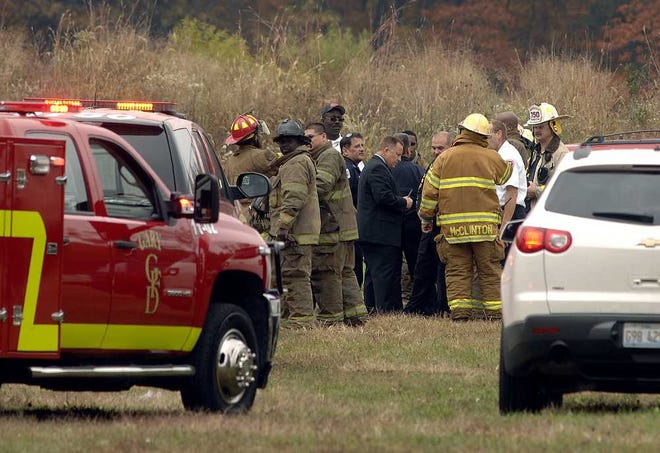 Stephanie Dowell Associated Press Emergency personnel confer at the site where a single-engine aircraft crashed in a wooded area in Gary, Ind., Wednesday, killing two men. The Cirrus SR22 single-engine plane was registered to Gandy Air LLC of St. Augustine.