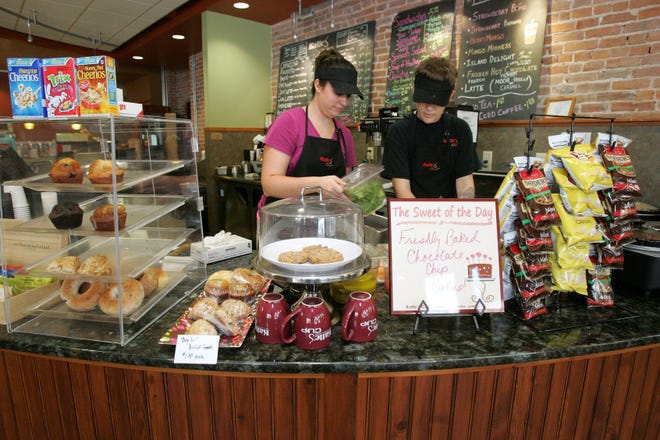 Heather Camacho, manager at Katie's Cup, (left) and Amelia Garcia, Katie's Cup barista, prepare food for customers Thursday, Oct. 4, 2012, during the lunch hour at Katie's Cup in Rockford.