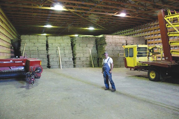 Hay and dairy farmer Brent Cottle of Spruce Creek Farm in Pickford stands in the empty space of his hay storage barn. Usually filled to the door, the hay barn is bare enough to store farm equipment thanks to this year's drought and low hay harvest. The hay not kept for his livestock will ship to Florida horse ranches sometime this winter.