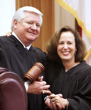 Associated Press In this 2006 photo, former chief justice Barbara Pariente passes the gavel to the new Florida Supreme Court Chief Justice Fred Lewis. A conservative group called Restore Justice 2012 has targeted the two justices as undeserving of a return to the court.